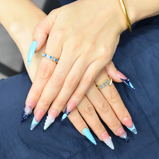 Blue Aurora press-on nails by You Are Angel with icy blue, navy, nude base, and crystal-like 3D accents.