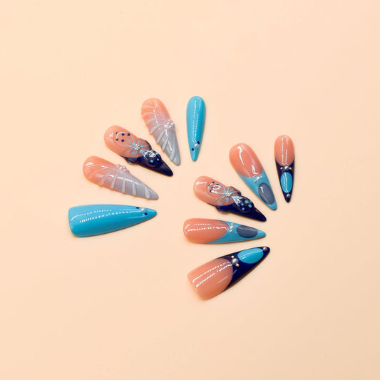 Blue Aurora press-on nails by You Are Angel with icy blue, navy, nude base, and crystal-like 3D accents.