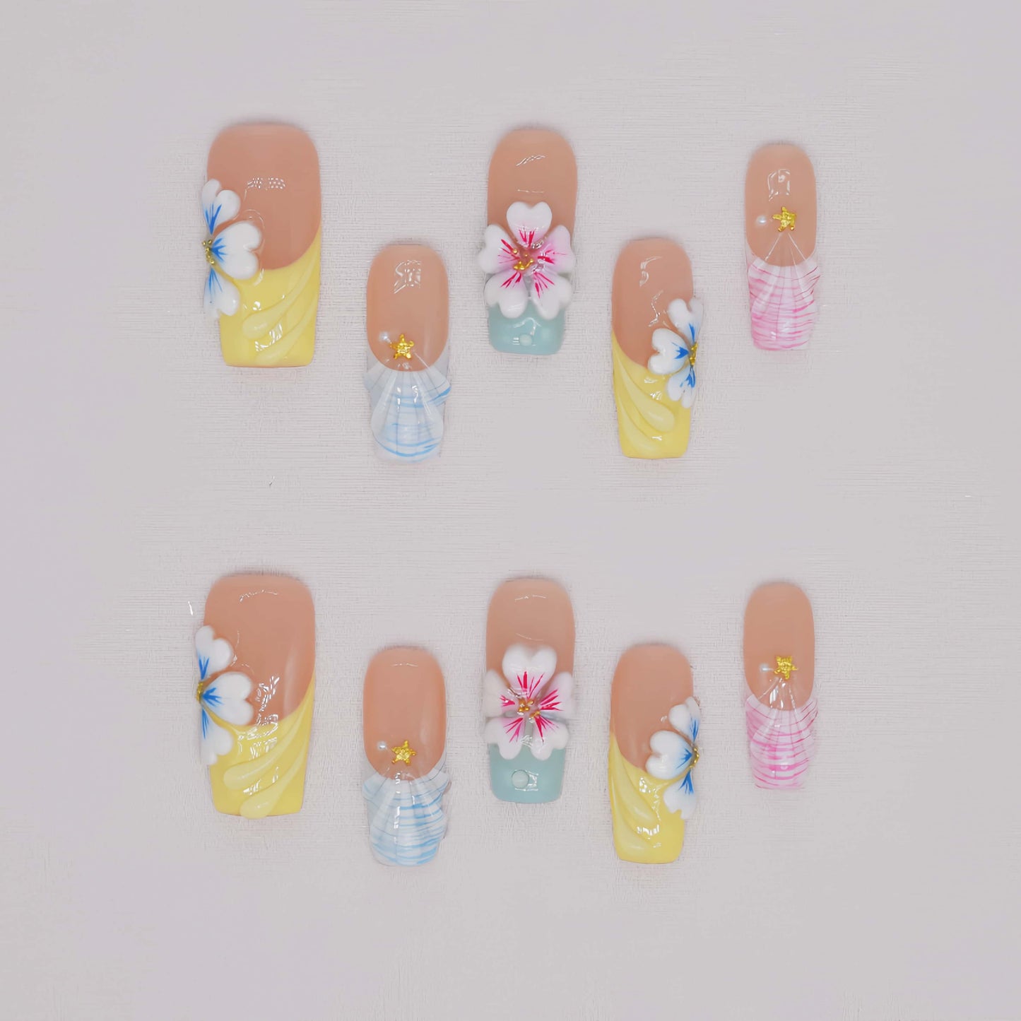 Handmade pastel floral press-on nails with 3D flower art, glossy sculpted details, and soft spring-inspired colors