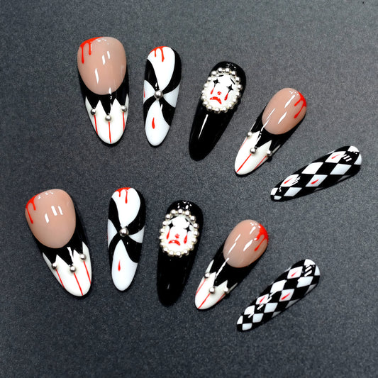 Halloween press-on nails with harlequin diamonds, blood-drip accents, and creepy clown design.