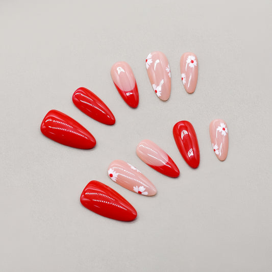 Cherry Petal press-on nails by You Are Angel with red and pink base, white floral details, and almond shape.