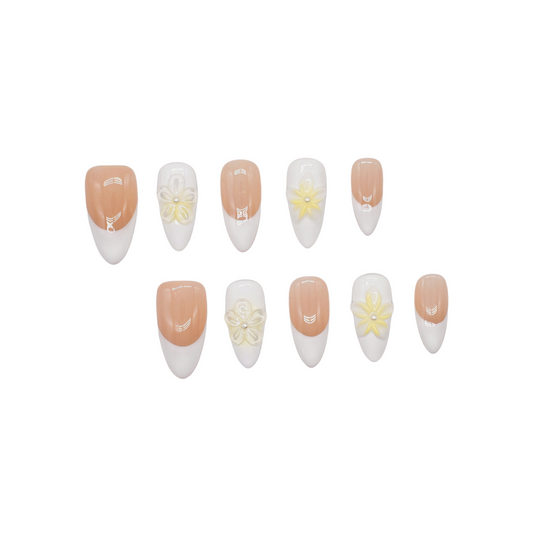 Elegant French tip press on nails with nude base, white tips, and 3D yellow floral accents – Heart & Beat Collection.