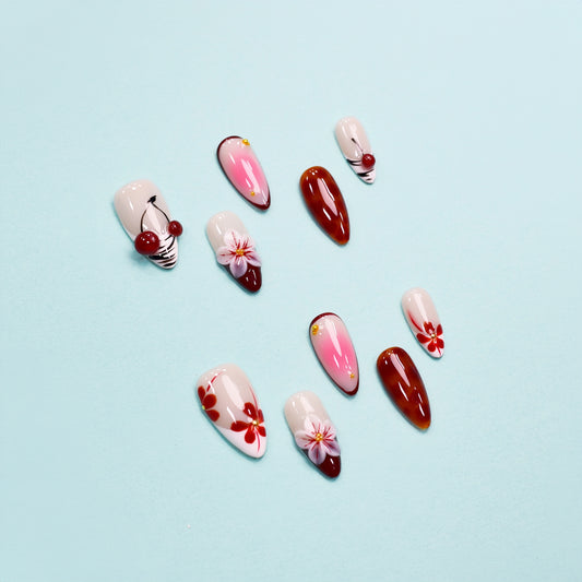 Red and pink ombre press on nails with 3D flowers, gemstone accents, and glossy finish – Heart & Heat Collection.