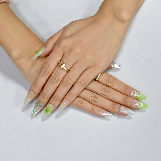 Green and white floral press-on nails with 3D blossoms, leaf detailing, and gold embellishments – handmade by You Are Angel.
