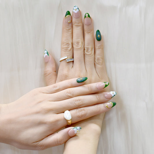 Press-on nails with emerald green French tips, white 3D blossoms, and gold swirl accents – Emerald Blossom.