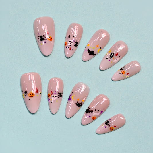 Halloween press-on nails with pumpkins, bats, spiders, and skull designs.