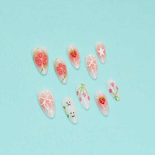 Handmade pink and white press-on nails with 3D bows, strawberry art, bunny design, and floral accents – Candy Bloom Collection