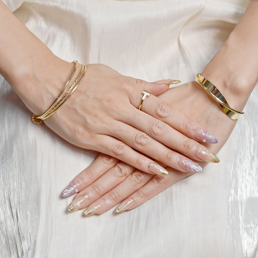 Sunset Pearl Bloom press-on nails in almond shape with peach-to-mauve ombré, golden swirls, and pearl accents – Tropical Bloom Collection