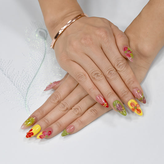 Tropical Fiesta press-on nails in long coffin shape with red, yellow, green, and lilac ombre base, 3D flowers, and gold bead accents.