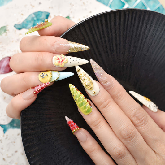 Colorful handmade fruit inspired press on nails featuring citrus slices, blueberry details and dessert inspired artwork.