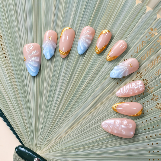 Gilded Azure Fan peach and blue press-on nails with sculpted pearl textures and gold accents — styled product photograph.