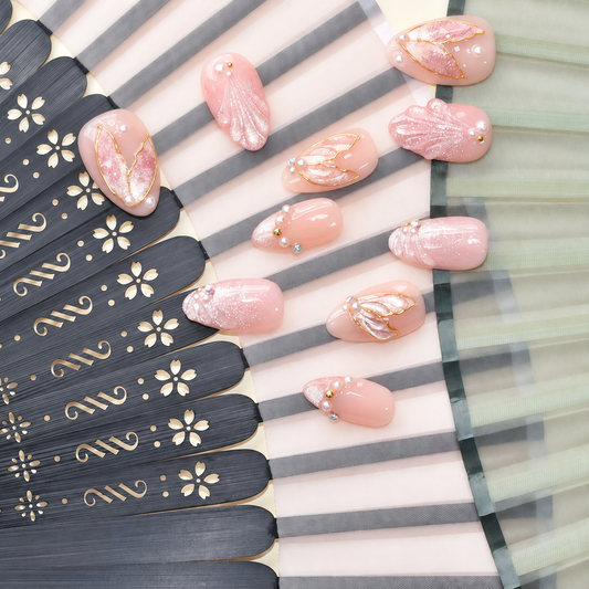 Rose Gold Leaf Veil peach press-on nails with translucent leaves, pearls and fine gold outlines — styled product photograph.