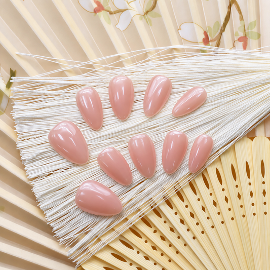 Bare Blush Veil reusable press-on nails in a sheer peach-pink nude with a glossy finish — styled product photograph.