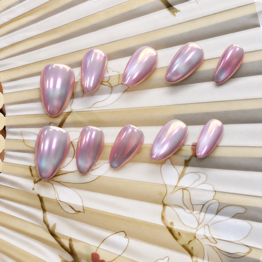 Pink Moon Chrome reusable press-on nails with a luminous blush-pink mirror finish — styled product photograph.