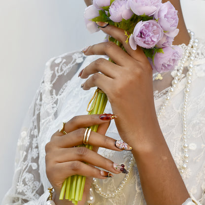 Autumn-inspired press-on nails with orange and amber tones, floral and lace details.