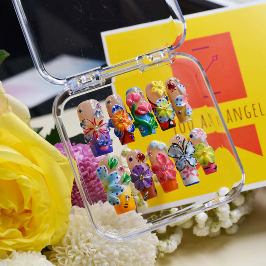 Handmade colorful floral press-on nails with 3D flower art, butterfly-inspired details, rhinestones, and glossy artistic finish