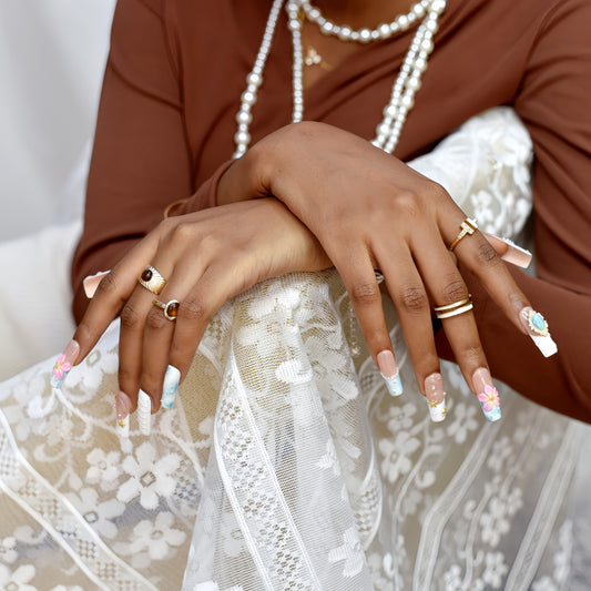 Blooming Sky Dreams press-on nails with pastel blue and pink floral accents.