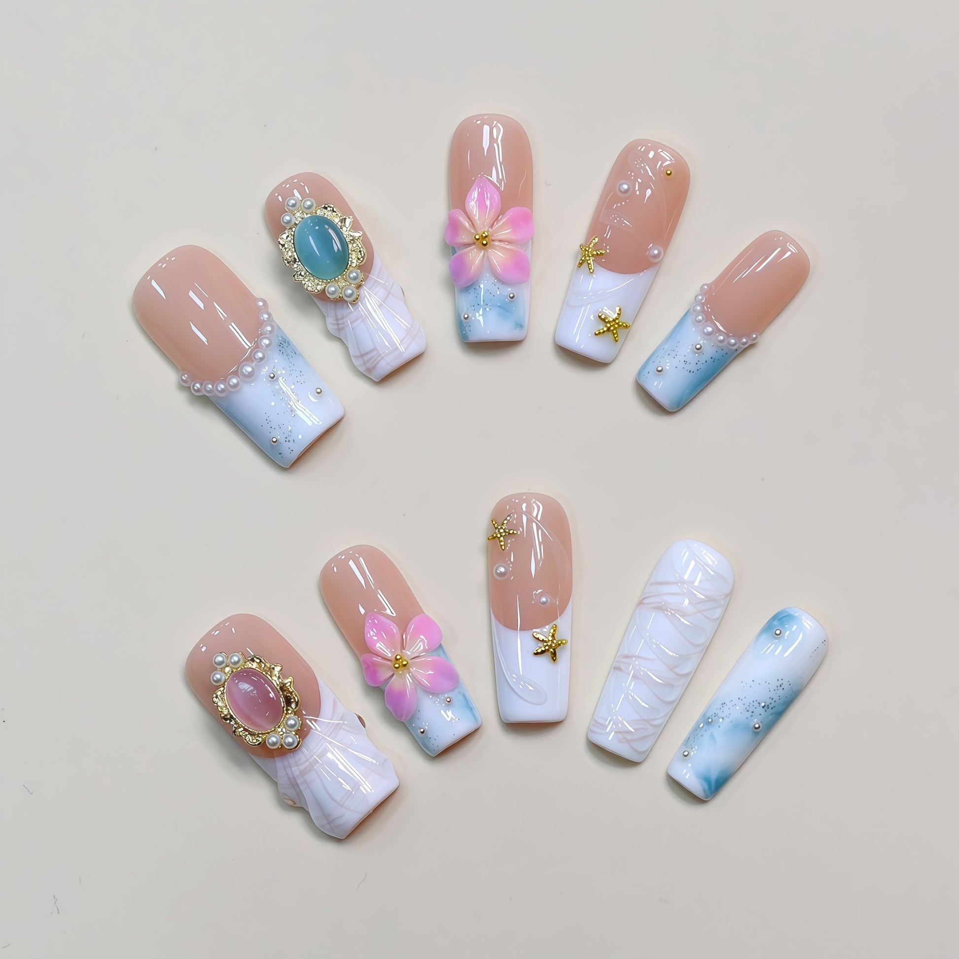 Blooming Sky Dreams press-on nails with pastel blue and pink floral accents.
