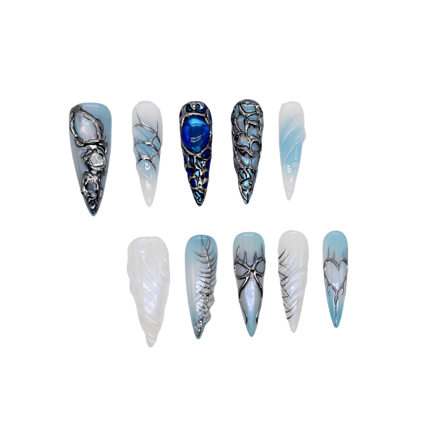 Long stiletto press-on nails in icy blue and silver with chrome textures, gemstone accents, and futuristic 3D design.