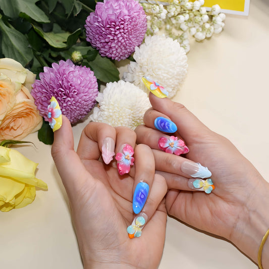 Handmade colorful tropical floral press-on nails with 3D hibiscus flowers, glossy sculpted details, and vibrant summer-inspired design