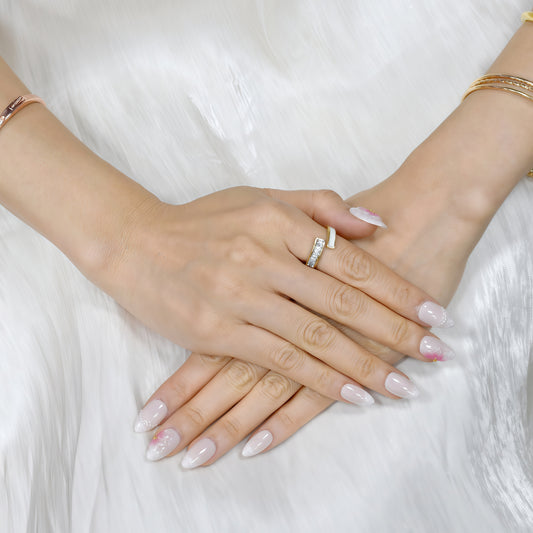 Close-up of two hands with pink nail polish on a white fur background