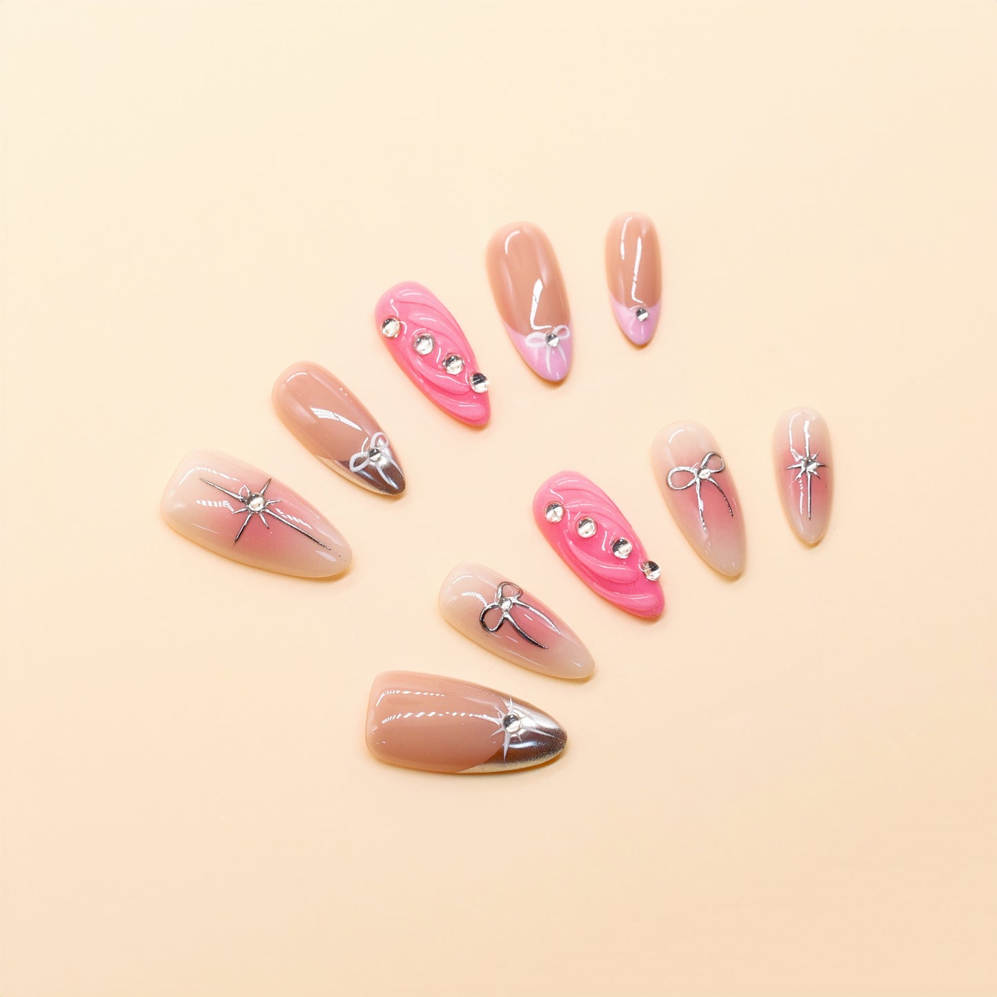 Pink ombre press on nails with silver bows and rhinestone accents – Heart & Beat Collection.
