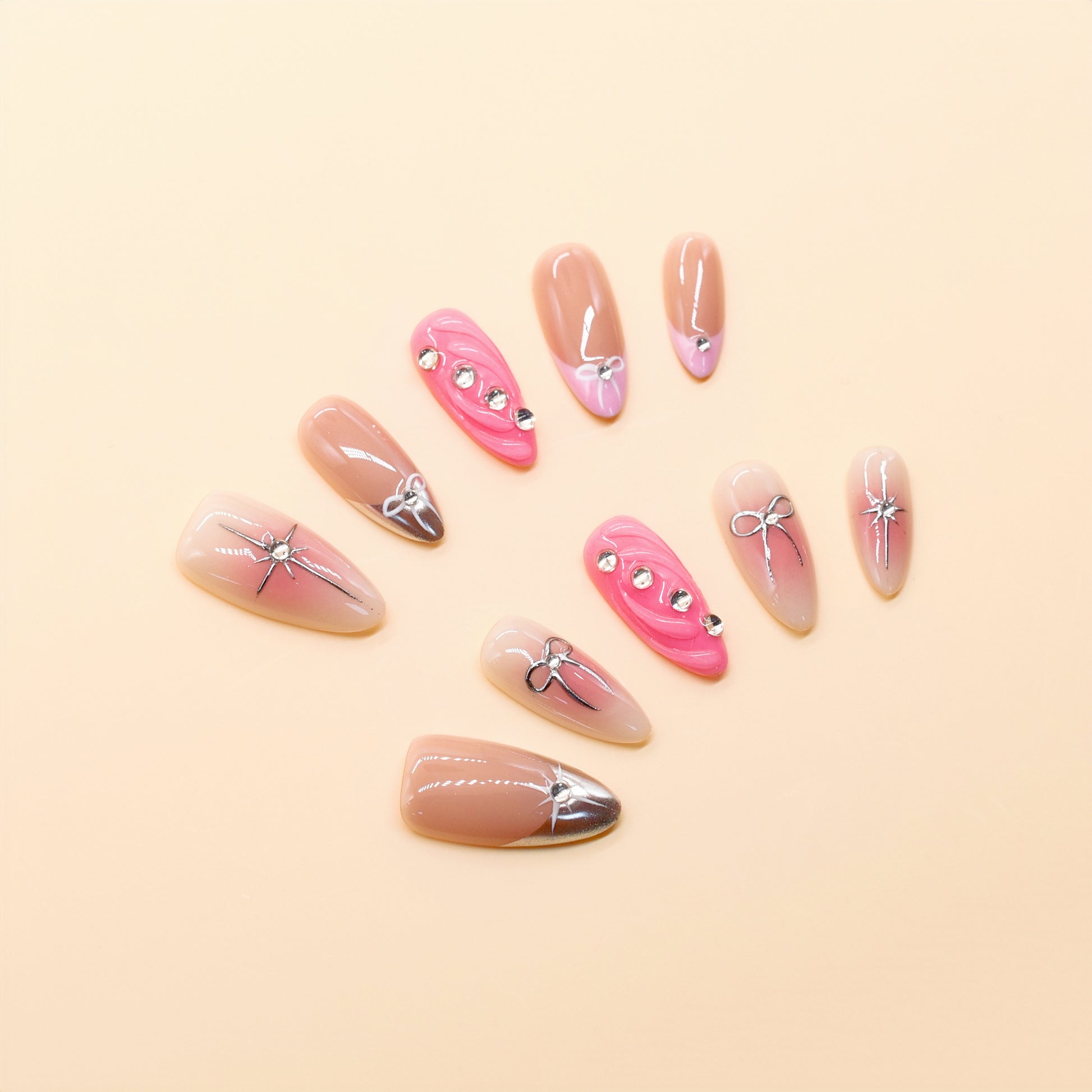 Pink ombre press on nails with silver bows and rhinestone accents – Heart & Beat Collection.