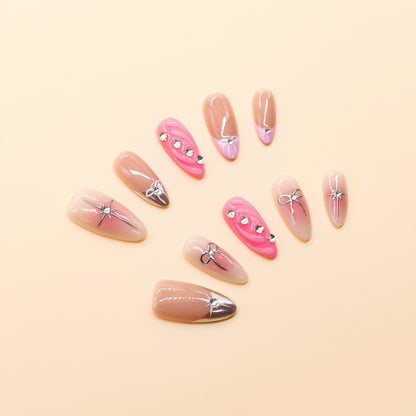 Pink ombre press on nails with silver bows and rhinestone accents – Heart & Beat Collection.