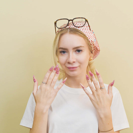 Blushing Petals press-on nails featuring pink shimmer base, 3D rose flowers, and gold accents for a soft romantic look.
