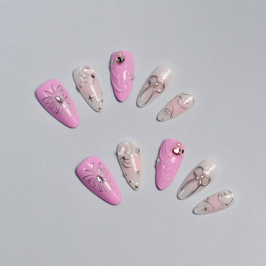 Pink and silver butterfly & bow press-on nails with rhinestone details – handcrafted romantic nail art.