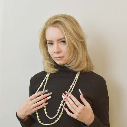 Candy Cane Spark press-on nails with red and white holiday designs, including snowflakes, hearts, and candy cane patterns.