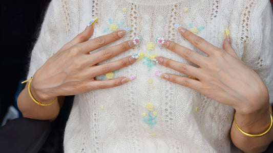 Handmade pastel floral press-on nails with 3D flower art, glossy sculpted details, and soft spring-inspired colors