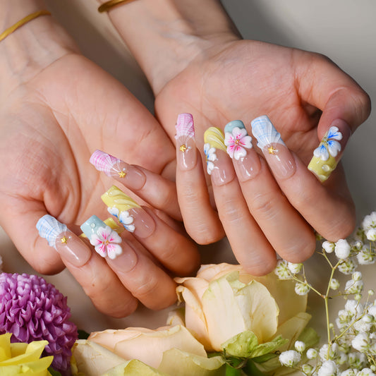 Handmade pastel floral press-on nails with 3D flower art, glossy sculpted details, and soft spring-inspired colors