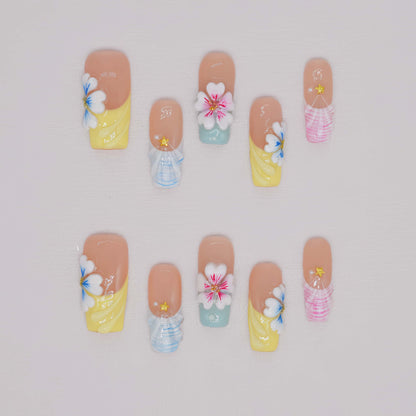 Handmade pastel floral press-on nails with 3D flower art, glossy sculpted details, and soft spring-inspired colors