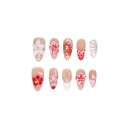 Cherry Bloom press-on nails with red and white flowers, pearl accents, and nude almond shape – handmade by You Are Angel.