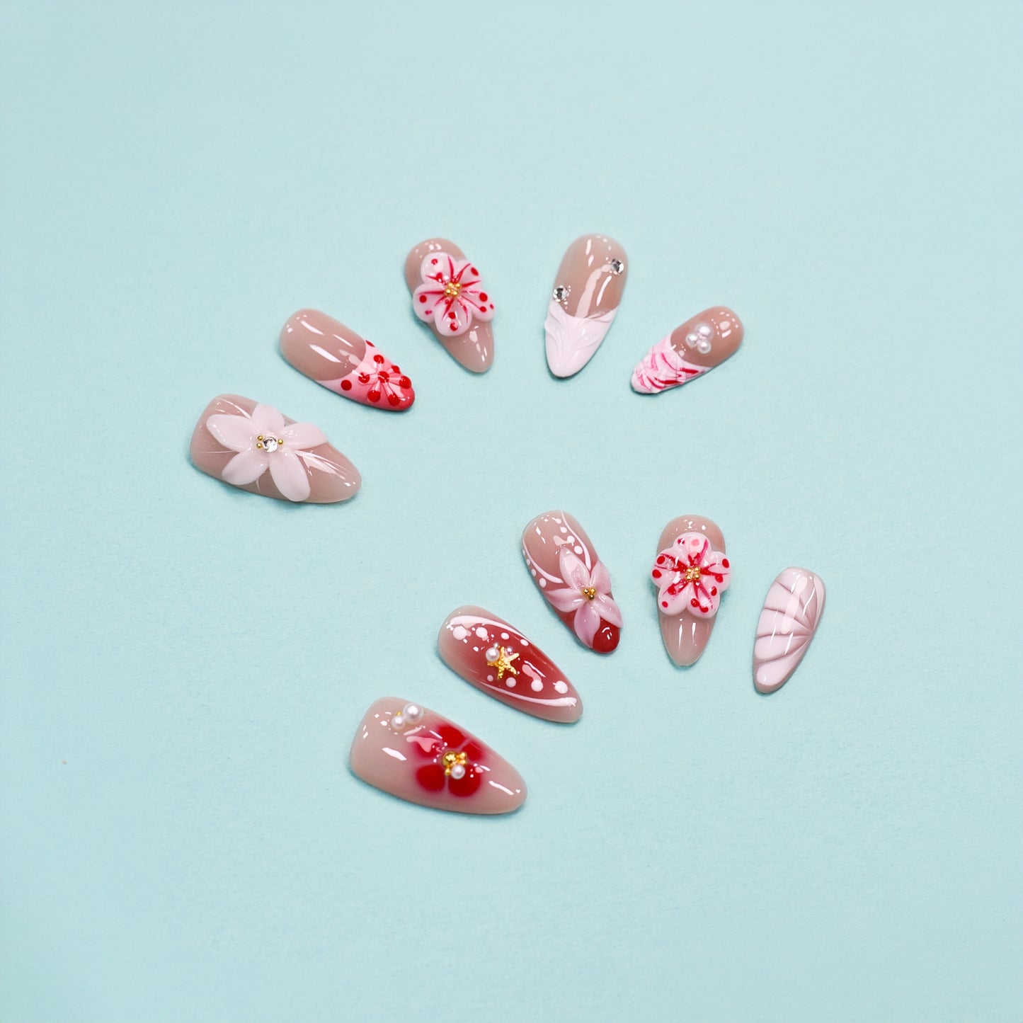 Cherry Bloom press-on nails with red and white flowers, pearl accents, and nude almond shape – handmade by You Are Angel.