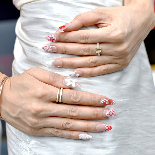 Cherry Bloom press-on nails with red and white flowers, pearl accents, and nude almond shape – handmade by You Are Angel.