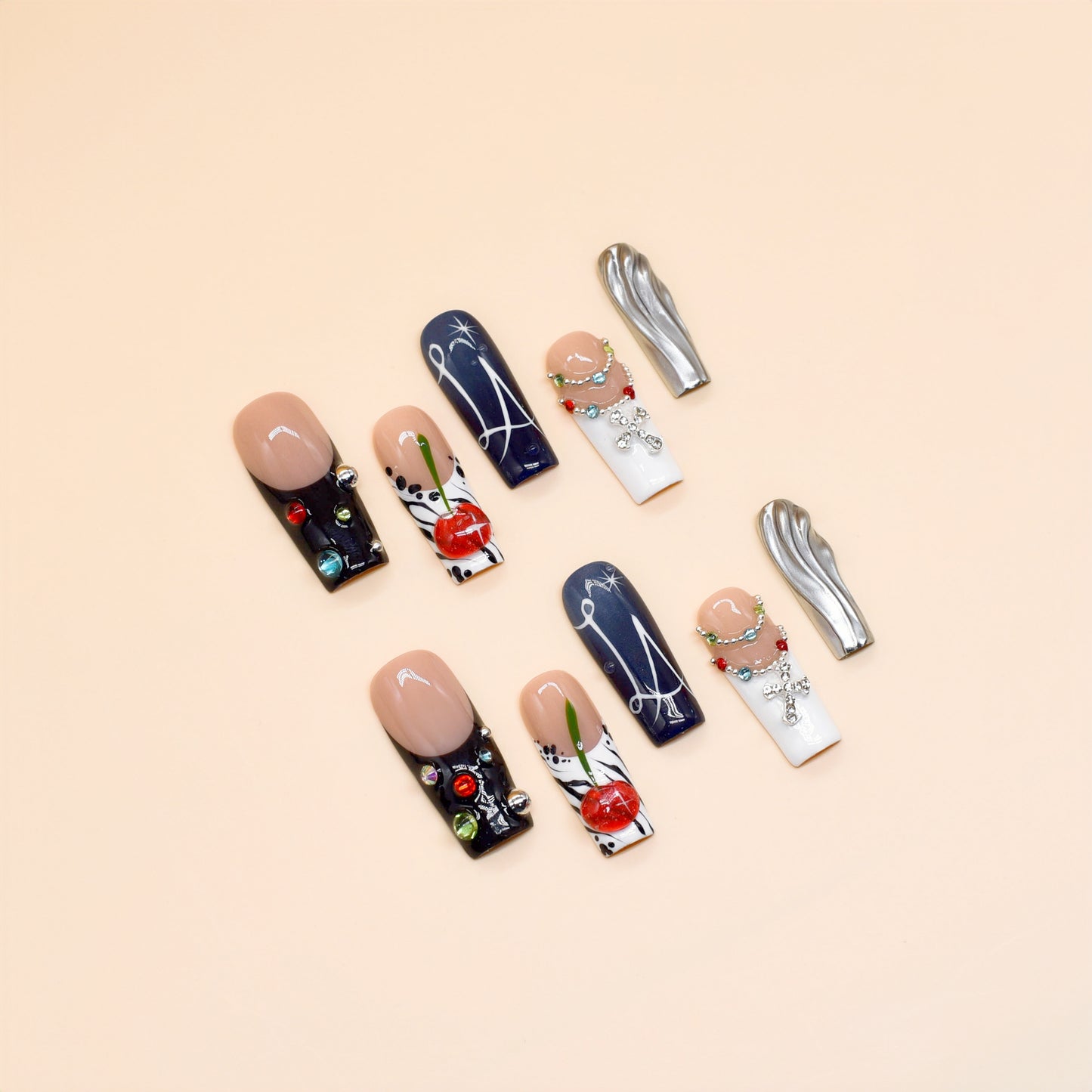 Black and white press on nails with red cherry art, gemstone chains, metallic silver accents, and modern abstract lines – Heart & Heat Collection.