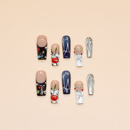 Black and white press on nails with red cherry art, gemstone chains, metallic silver accents, and modern abstract lines – Heart & Heat Collection.