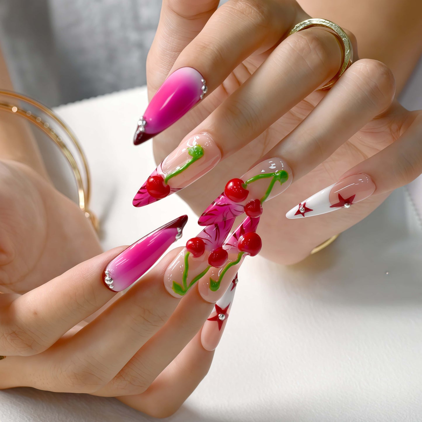 Cherry Pop Star press-on nails featuring pink ombre, 3D cherry accents, and red star details on a glossy nude base.