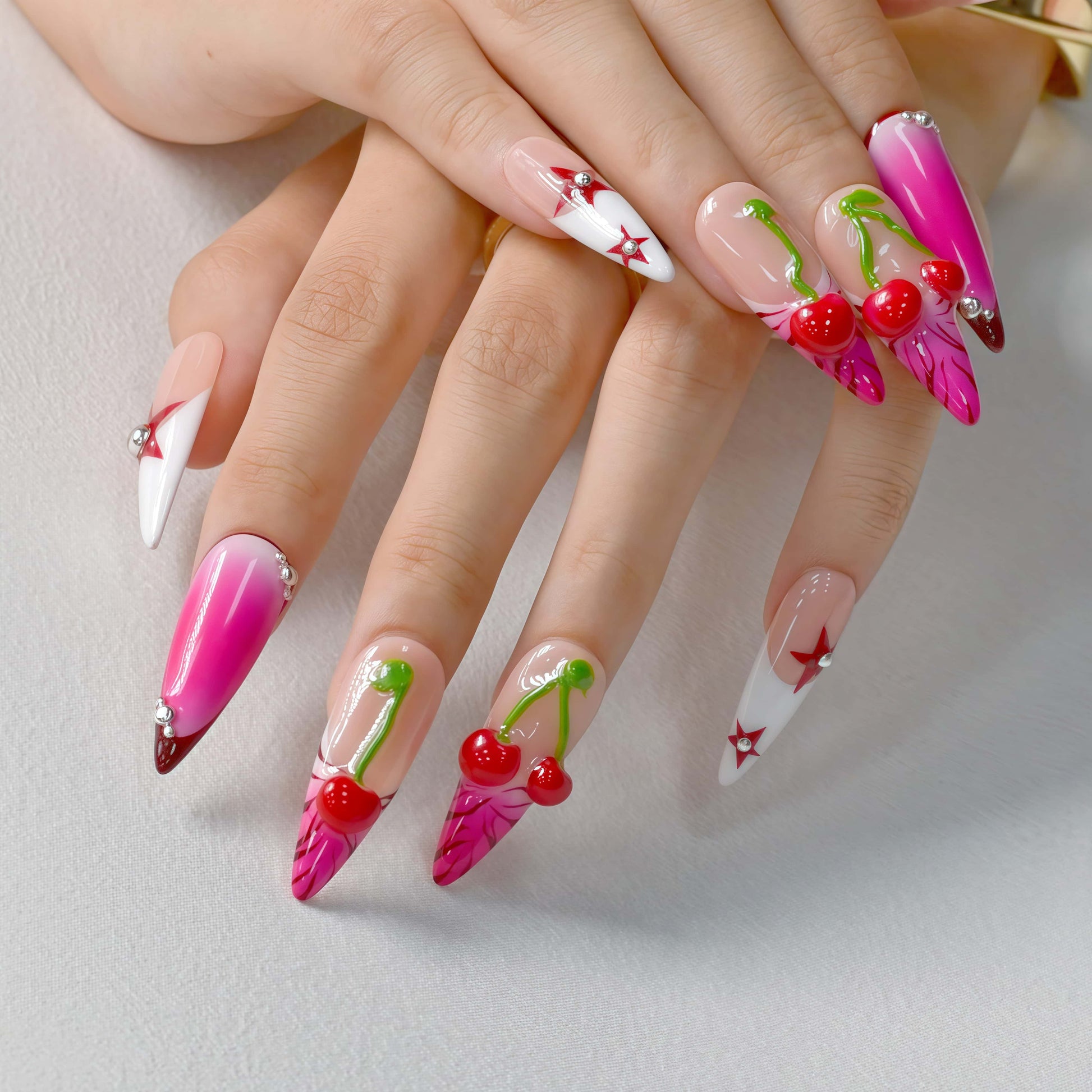 Cherry Pop Star press-on nails featuring pink ombre, 3D cherry accents, and red star details on a glossy nude base.