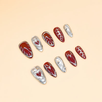 Chrome Heart handmade press-on nails by You Are Angel featuring burgundy base, silver 3D hearts, and sculpted chrome elements.