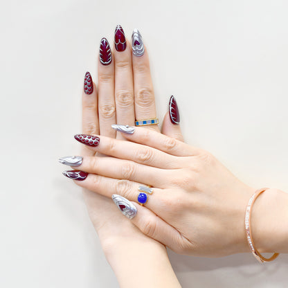 Chrome Heart handmade press-on nails by You Are Angel featuring burgundy base, silver 3D hearts, and sculpted chrome elements.