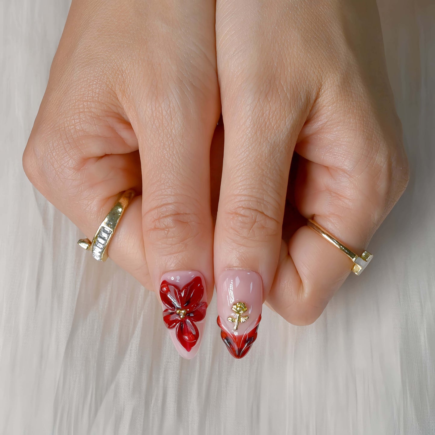 Crimson Bloom press-on nails featuring deep red floral 3D designs, gold details, and glossy pink base for an elegant, romantic look.