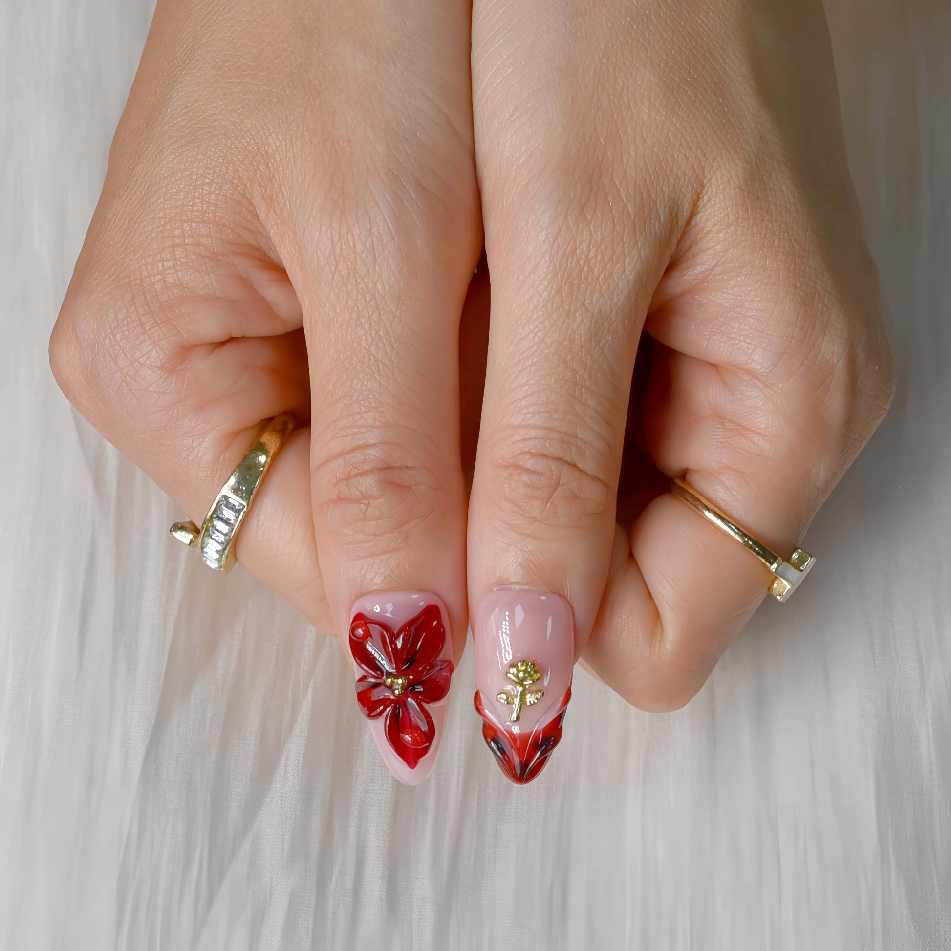 Crimson Bloom press-on nails featuring deep red floral 3D designs, gold details, and glossy pink base for an elegant, romantic look.