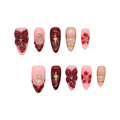 Crimson Bloom press-on nails featuring deep red floral 3D designs, gold details, and glossy pink base for an elegant, romantic look.