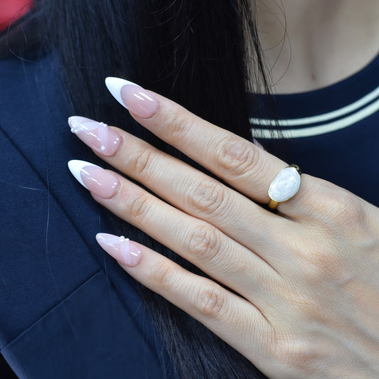 Crystal Dew almond press-on nails with soft pink base, clear tips, and 3D droplet accents.