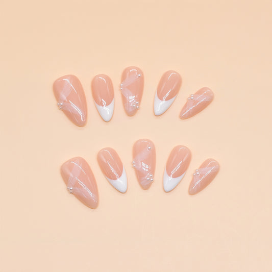 Crystal Dew almond press-on nails with soft pink base, clear tips, and 3D droplet accents.