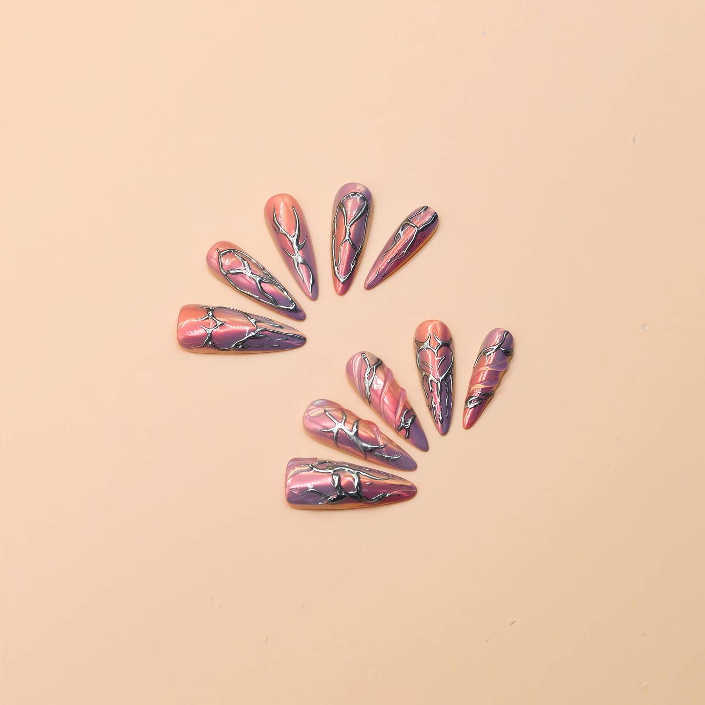 Cyber Crush press-on nails by You Are Angel with pink-purple chrome base and sculpted silver metallic designs in long stiletto shape.