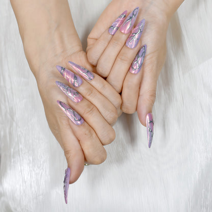 Cyber Crush press-on nails by You Are Angel with pink-purple chrome base and sculpted silver metallic designs in long stiletto shape.